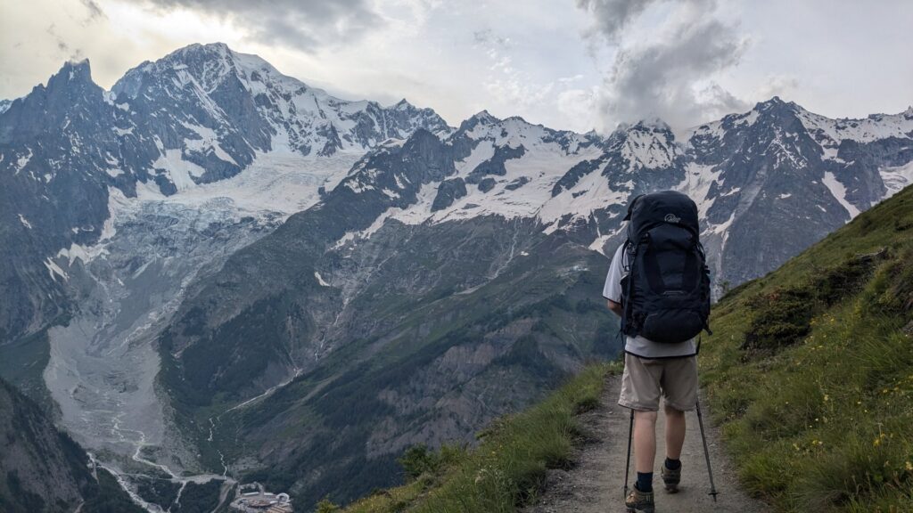 a person with backpack walking on the TMB with Mont Blanc view,  Courmayeur → Tronchey
