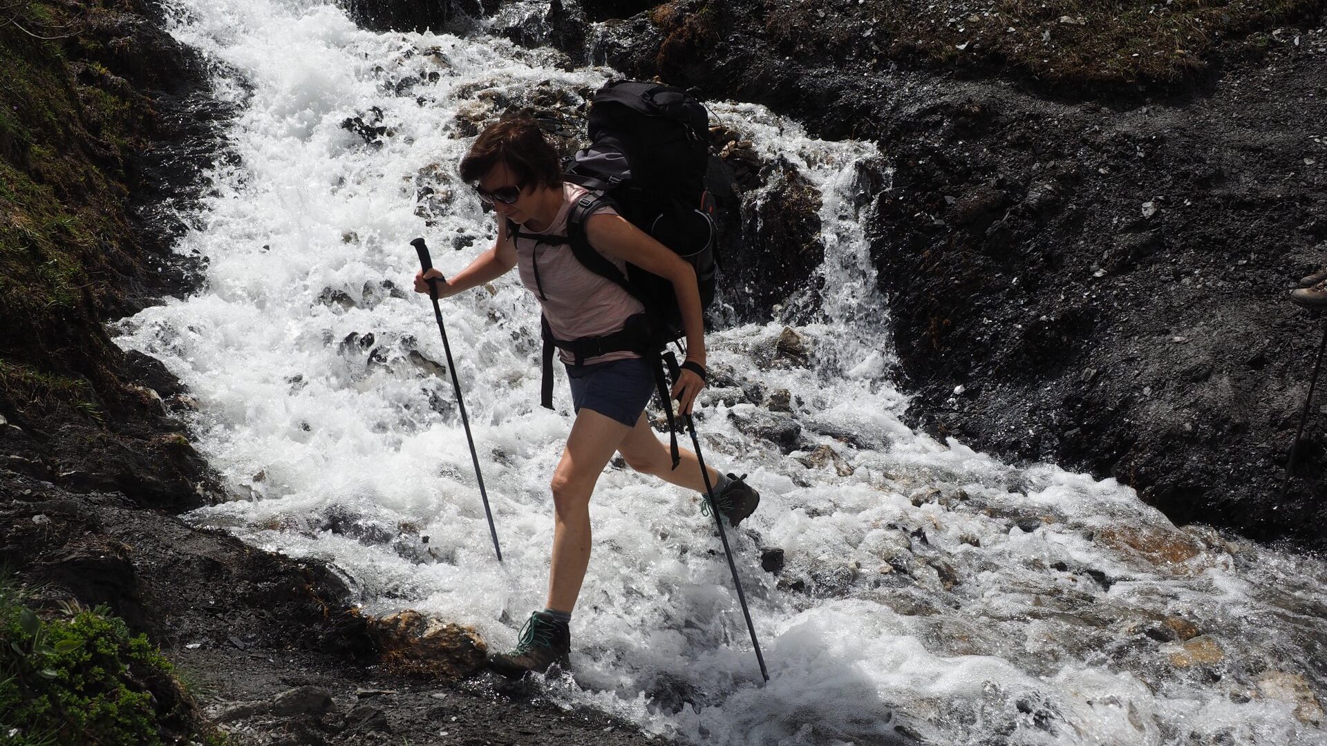 mountain river crossing with havy backpack, Tour du Mont Blanc,