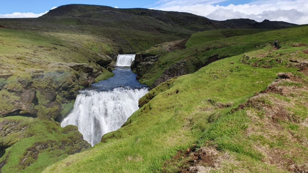 View of the Skógafoss Waterfall Way (Fimmvörðuháls Trail) with waterfalls and green canyons near Skógar, Iceland