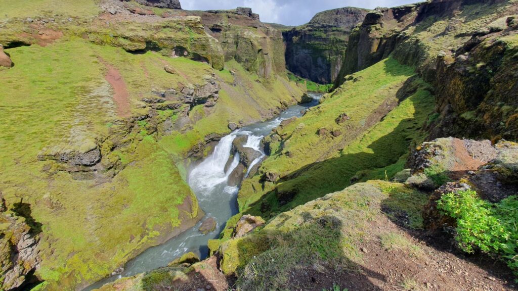 Waterfall flowing through a deep canyon on the Skógafoss Waterfall Way near Skógar, Iceland.