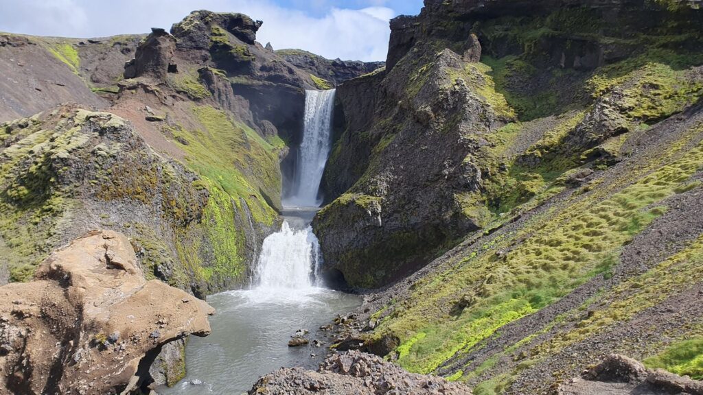 Waterfall cascading into a narrow canyon on the Skógafoss Waterfall Way near Skógar, Iceland.