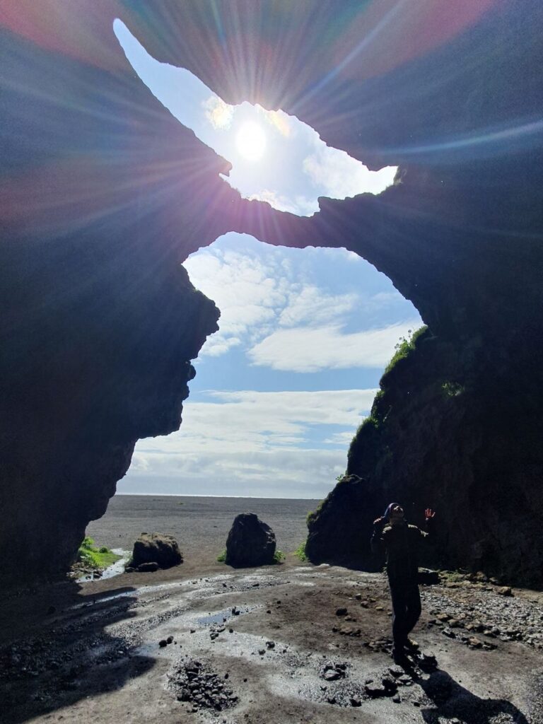 Sunlight shining through the entrance of Yoda Cave (Gígjagjá) on Iceland's South Coast, Iceland.
