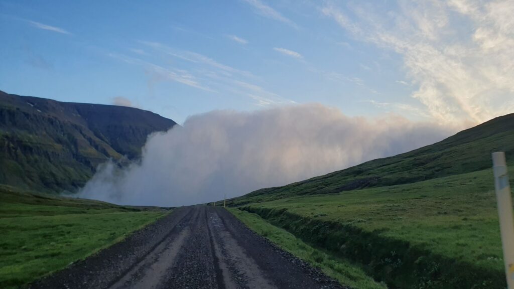 Road disappearing into a massive bank of fog in East Iceland.