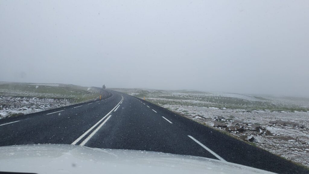 Driving through snow on the road to Ásbyrgi in North Iceland.