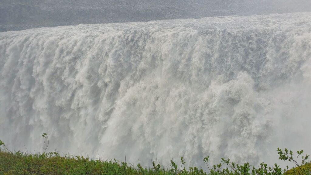 Close-up view of the immense curtain of water at Dettifoss waterfall.