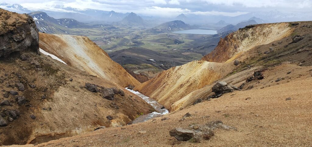 View from the trail descending towards Álftavatn through colorful volcanic mountains and valleys.